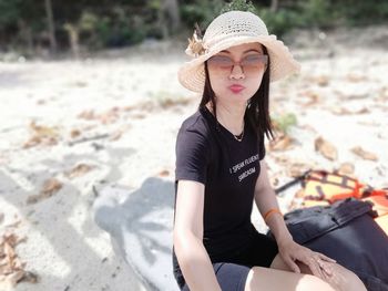 Young woman sitting on sand