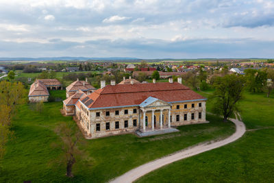 Aerial view about abandoned cziraky castle with cloudy sky at the background.