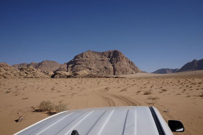 Scenic view of desert against clear blue sky