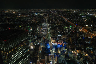 Aerial view of illuminated city buildings at night