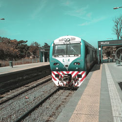 Train at railroad station platform against sky