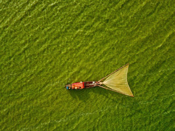 Aerial view of fishing boat moored at harbor