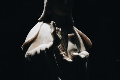 Man holding hair over black background