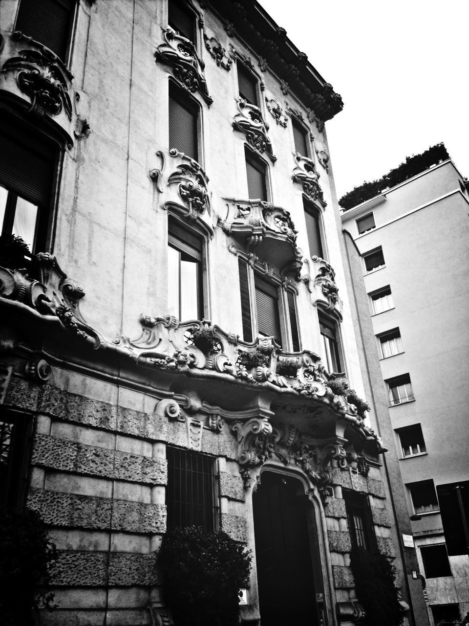architecture, building exterior, built structure, low angle view, window, building, residential building, residential structure, city, facade, outdoors, day, sky, no people, balcony, clear sky, exterior, house, old, brick wall