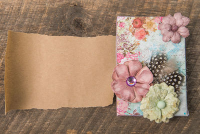 Close-up of hand holding pink flower in box