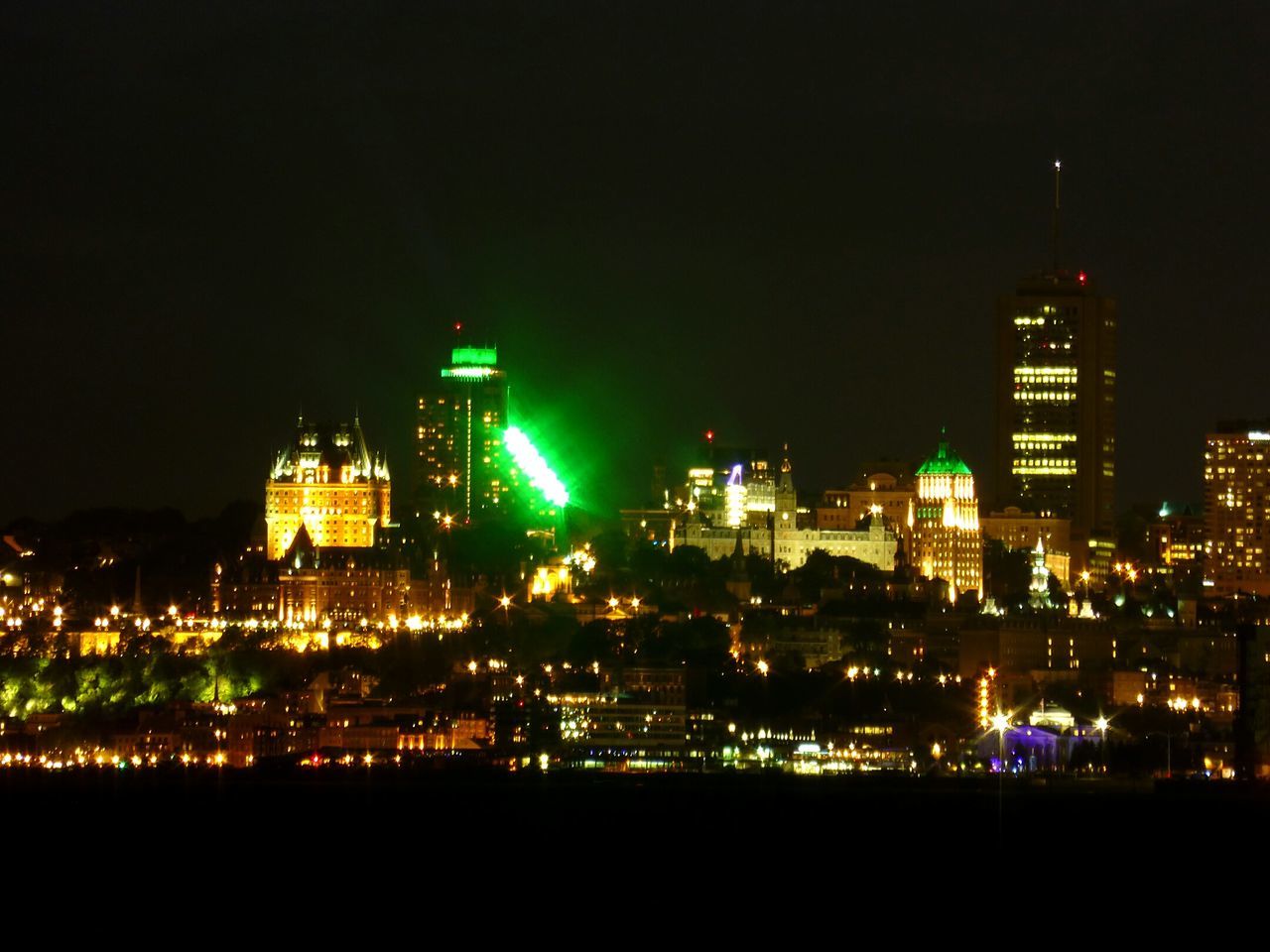 ILLUMINATED CITYSCAPE AGAINST SKY