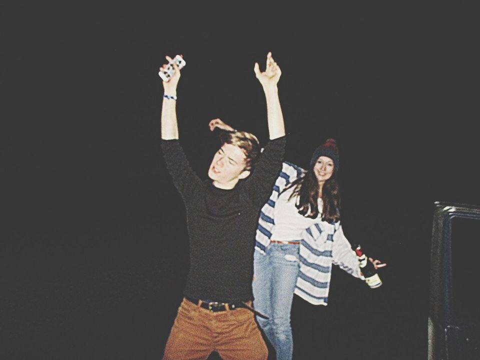 lifestyles, casual clothing, standing, leisure activity, young adult, full length, copy space, front view, three quarter length, holding, night, young men, person, men, portrait, indoors, togetherness