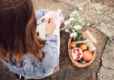 High angle view of woman standing by potted plant