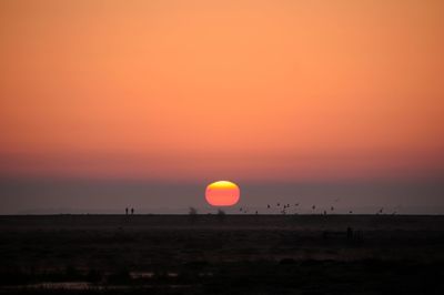 Scenic view of silhouette landscape against romantic sky at sunset