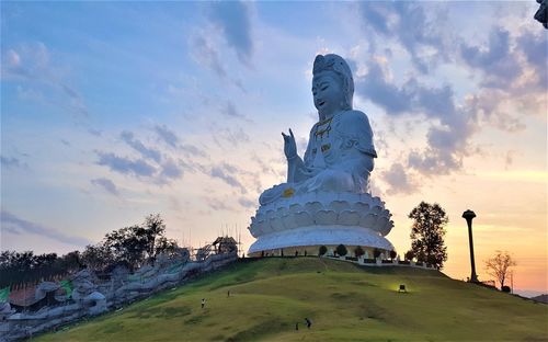 Low angle view of statue against cloudy sky