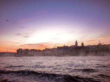 Buildings in city at sunset