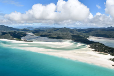 Scenic view of sea and mountains against sky