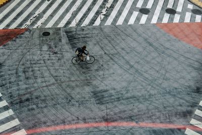 High angle view of man riding bicycle on street