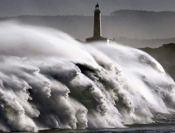 Lighthouse against cloudy sky