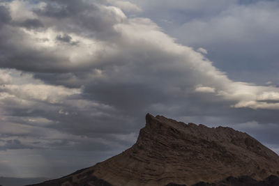 Low angle view of rock formation against sky