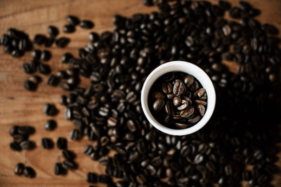 Coffee cup filled with coffee beans top view