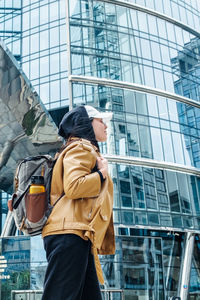 Low angle view of man standing against building