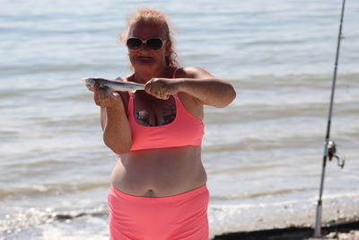 Woman wearing sunglasses on beach