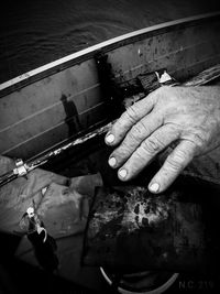 Hands of person preparing food.
