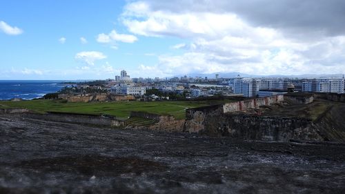Scenic view of sea and buildings against sky