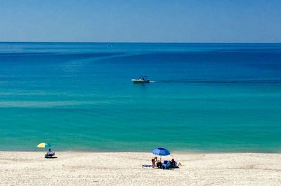 Scenic view of sea against blue sky