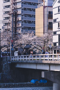 Bridge over river against buildings