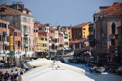 Canal, historic buildings, architecture, sunshine and chill in venice, italy
