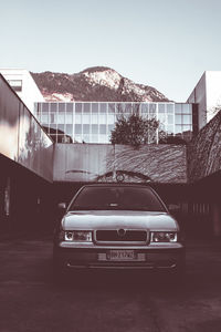 Car on street against buildings in city