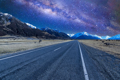 Scenic view of snowcapped mountains against sky at night