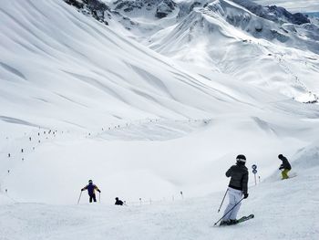 People skiing on snowcapped mountain in lech 