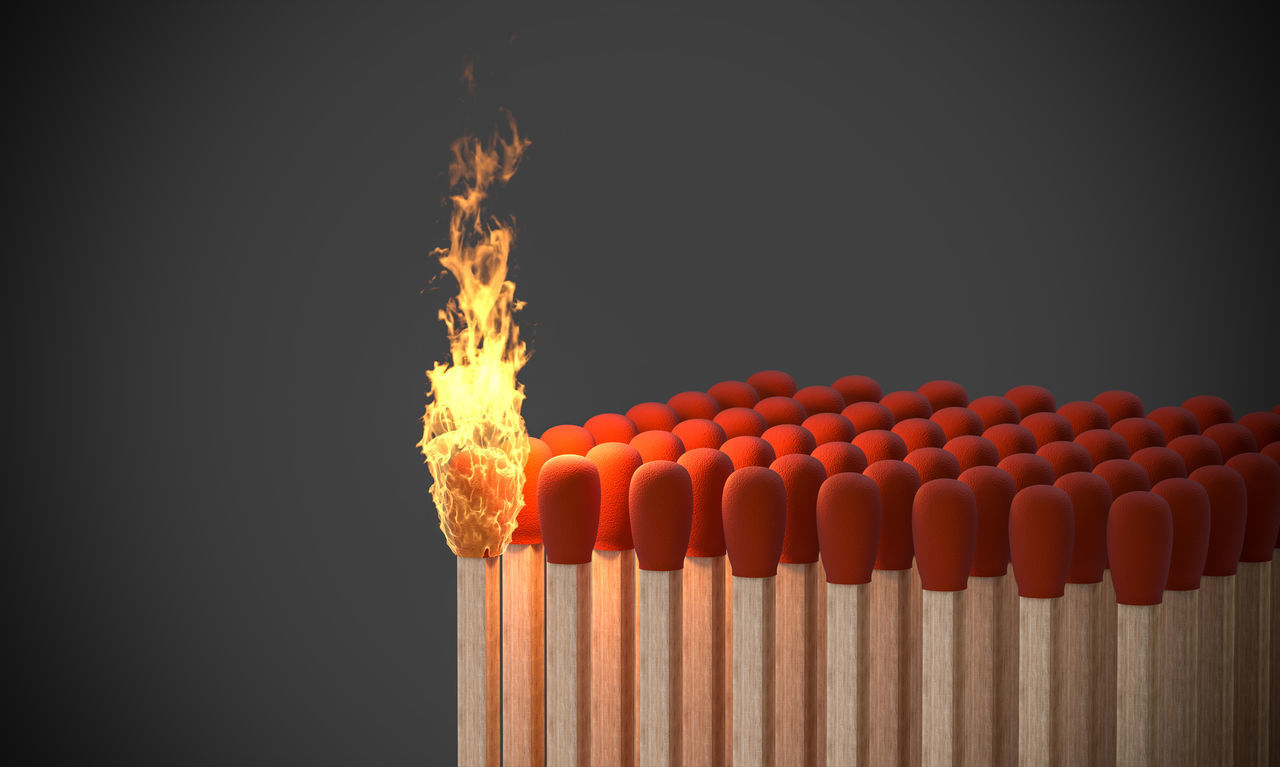 CLOSE-UP OF BURNING CANDLES ON WOOD AGAINST BLACK BACKGROUND