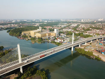 High angle view of bridge over river amidst buildings in city