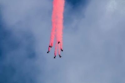 Low angle view of airshow against sky