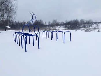 Scenic view of snow covered field against sky