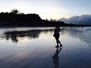 Scenic view of lake at sunset