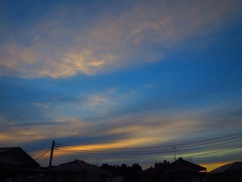 Low angle view of silhouette roof against sky during sunset