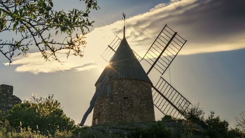 Low angle view of traditional building against sky during sunset