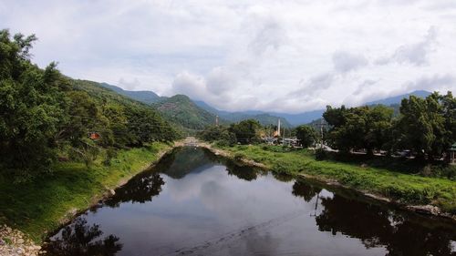 Scenic view of lake and mountains against sky