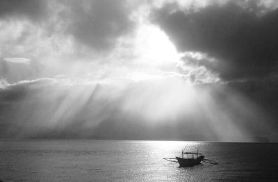 Boat sailing on sea against sky