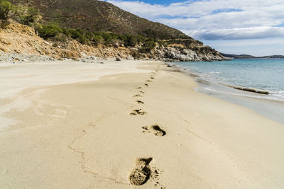 Footprints on sand at piscadeddu's beach