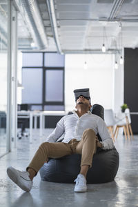 Young man sitting on floor