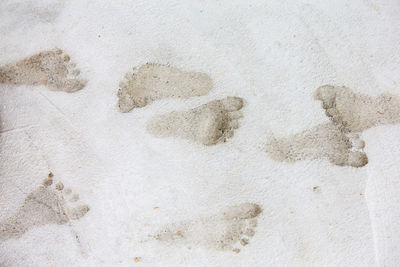 High angle view of footprints on sand at beach