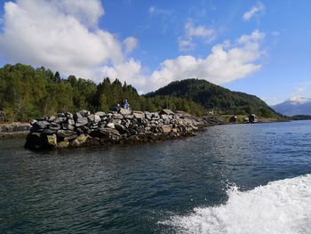 Scenic view of rocks in sea against sky
