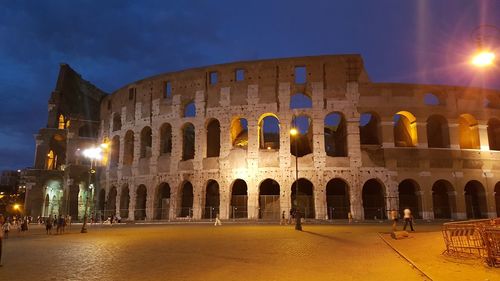 Low angle view of coliseum at night