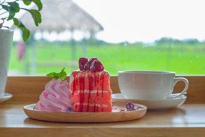 Close-up of ice cream with drink on table