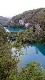 Scenic view of lake and mountains against clear sky