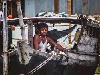 Portrait of man working on metal