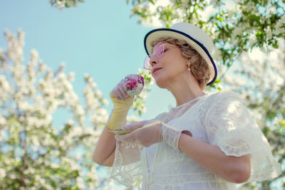 Young woman holding flower
