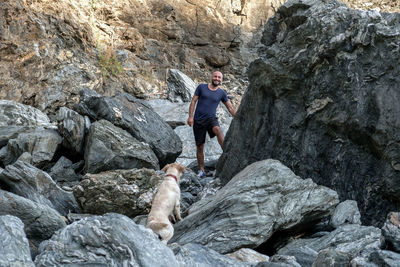 Full length of man on rocks by rock formation