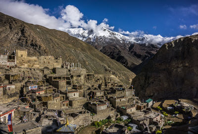 Panoramic view of townscape and mountains against sky